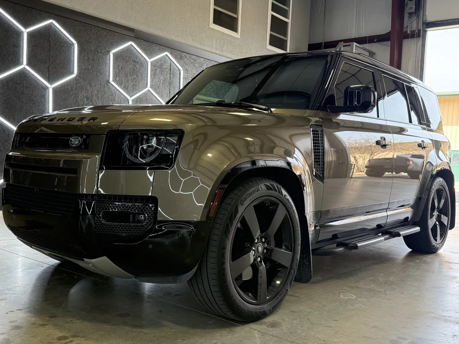 Land Rover Defender in shop - professional hail inspection