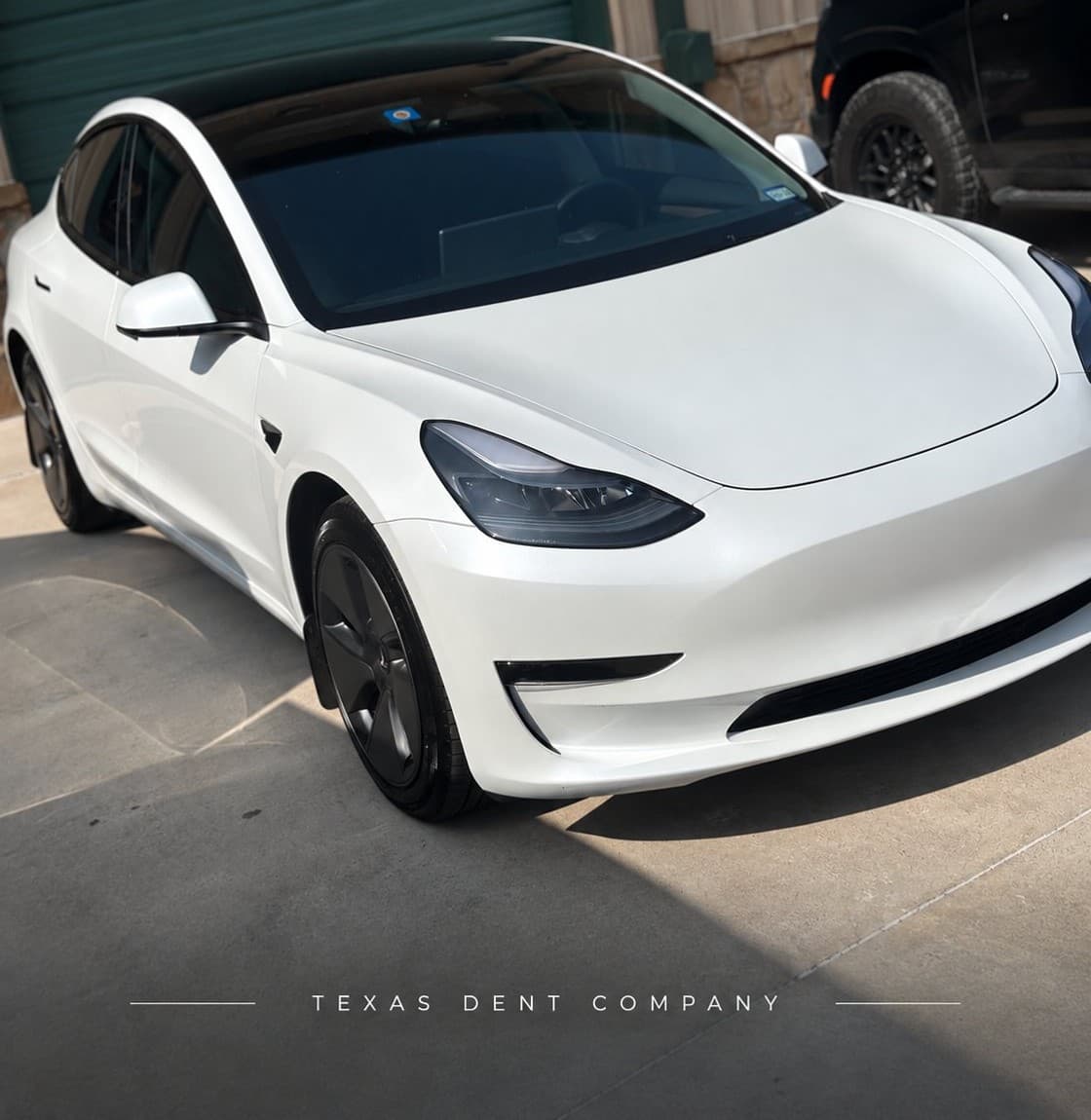 White Tesla Model 3 at the Texas Dent Company Frisco facility